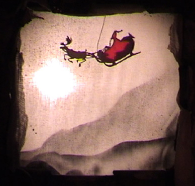 Le Père Noël sur son traîneau en silhouette pour théâtre d'ombres dans le spectacle pour enfants de Noel-en-Chocolat.